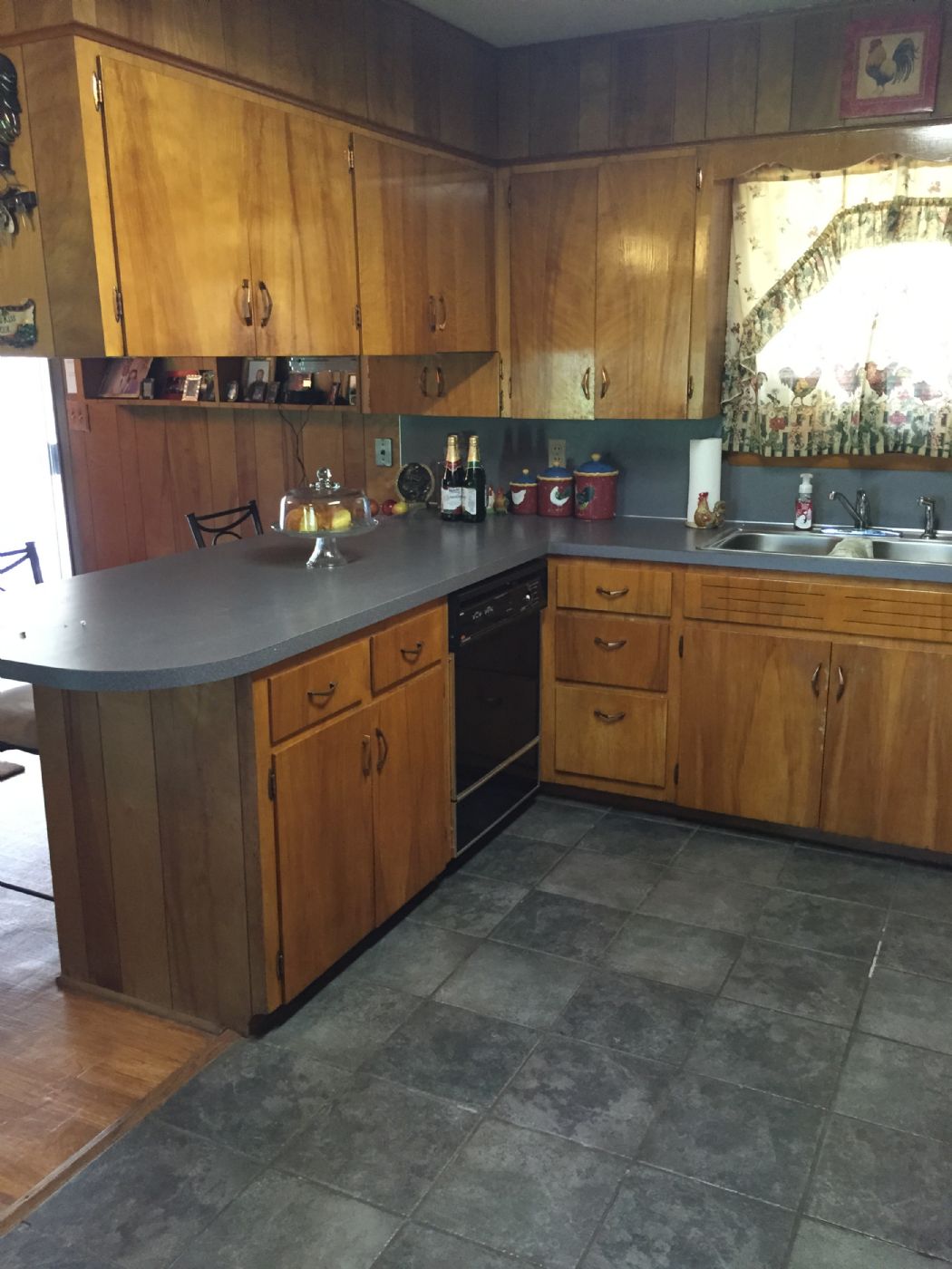 Stained wood cabinets, gas cook top stove , tile flooring